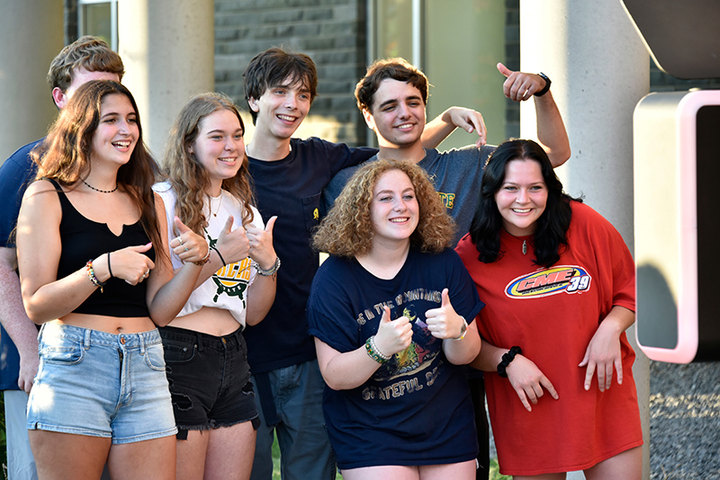 Seven students pose for the Photo Booth at the Opening Picnic and Carnival 