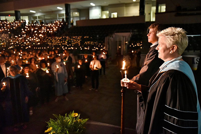 The 33rd Annual Welcoming Torchlight Ceremony officially welcomed the newest members of the SUNY Oswego community in a ceremony held Aug. 19 in the Deborah F. Stanley Arena and Convocation Hall in Marano Campus Center. Mary Toale, College Officer in Charge, and Thomas Ehrhard, student association president and class of 2024 who served as torchbearer for the event, are pictured singing the Alma Mater from the platform along with faculty, staff and students in attendance.