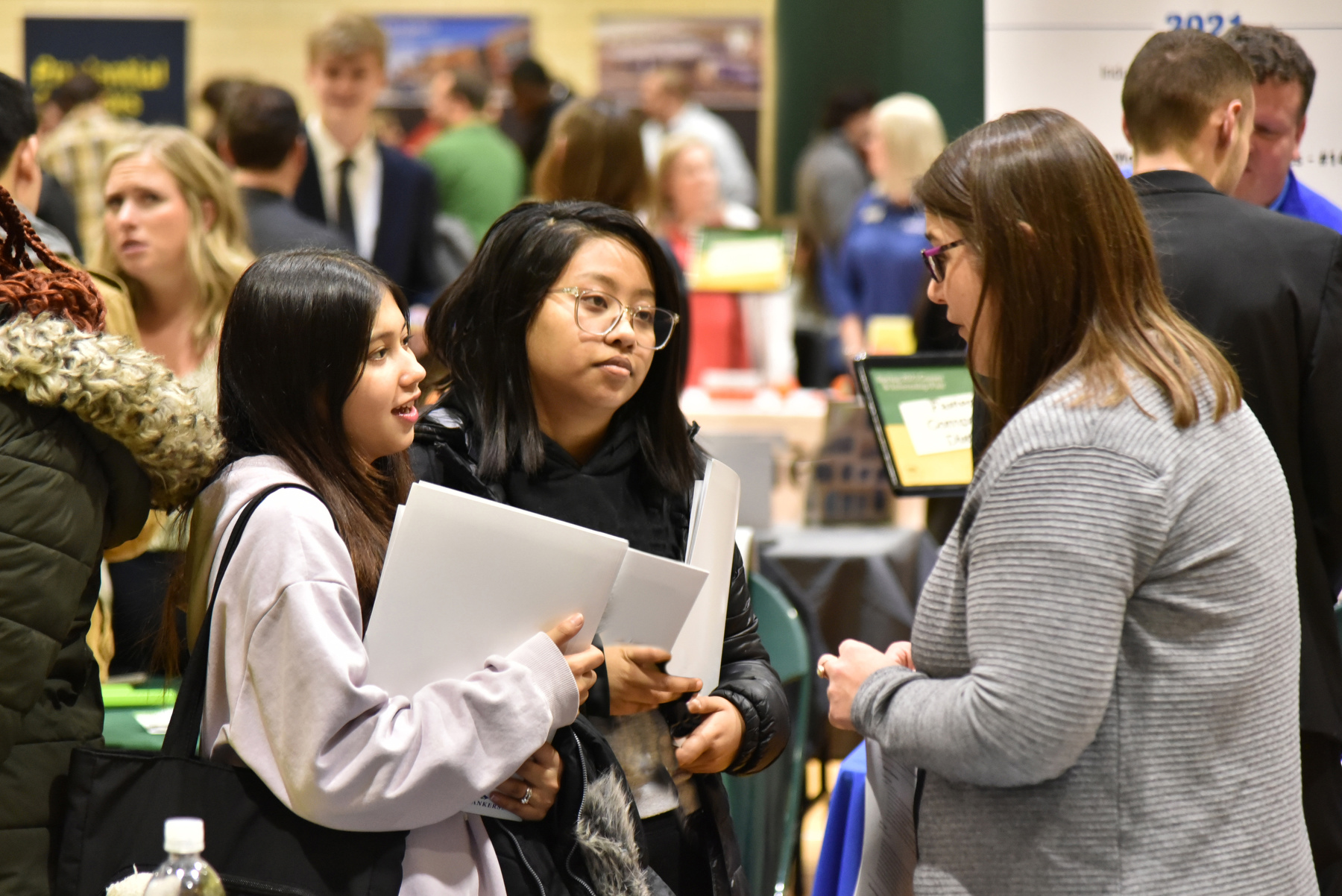 Freshman business majors Rohini Khadka (left) and Shriya Shahi meeting with Nicole Montgomery, a 2010 SUNY Oswego graduate and operations administrator for Brown and Brown Insurance of NY. 