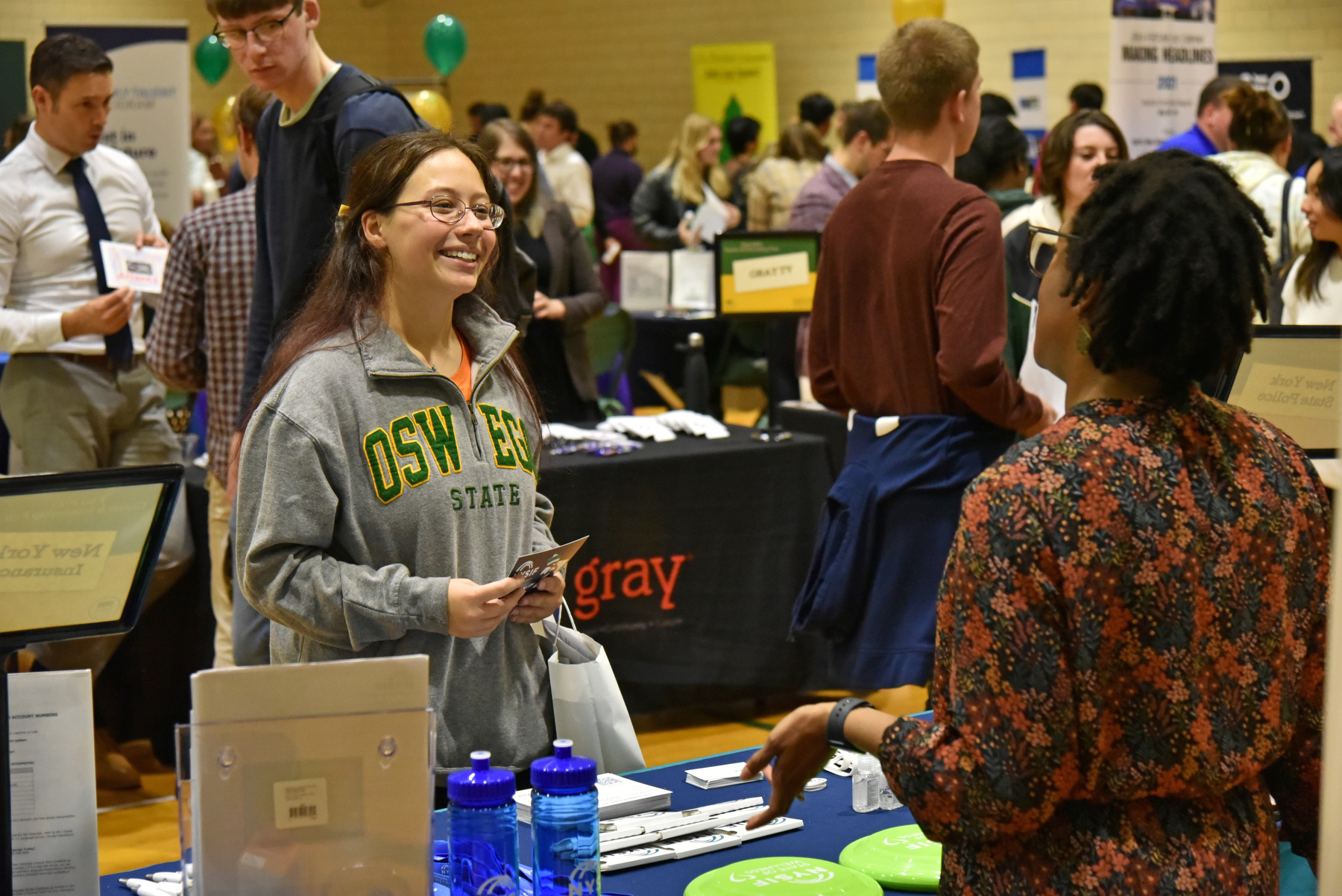 Oswego students took advantage of the opportunity to network with 100+ employers at the Fall 2023 Career and Internship Fair. The Oct. 18 event was hosted by Career Services and held in the Swetman Gym in the Marano Campus Center. Pictured is Jocelyn Decker talking with a representative from NYS Insurance Fund.