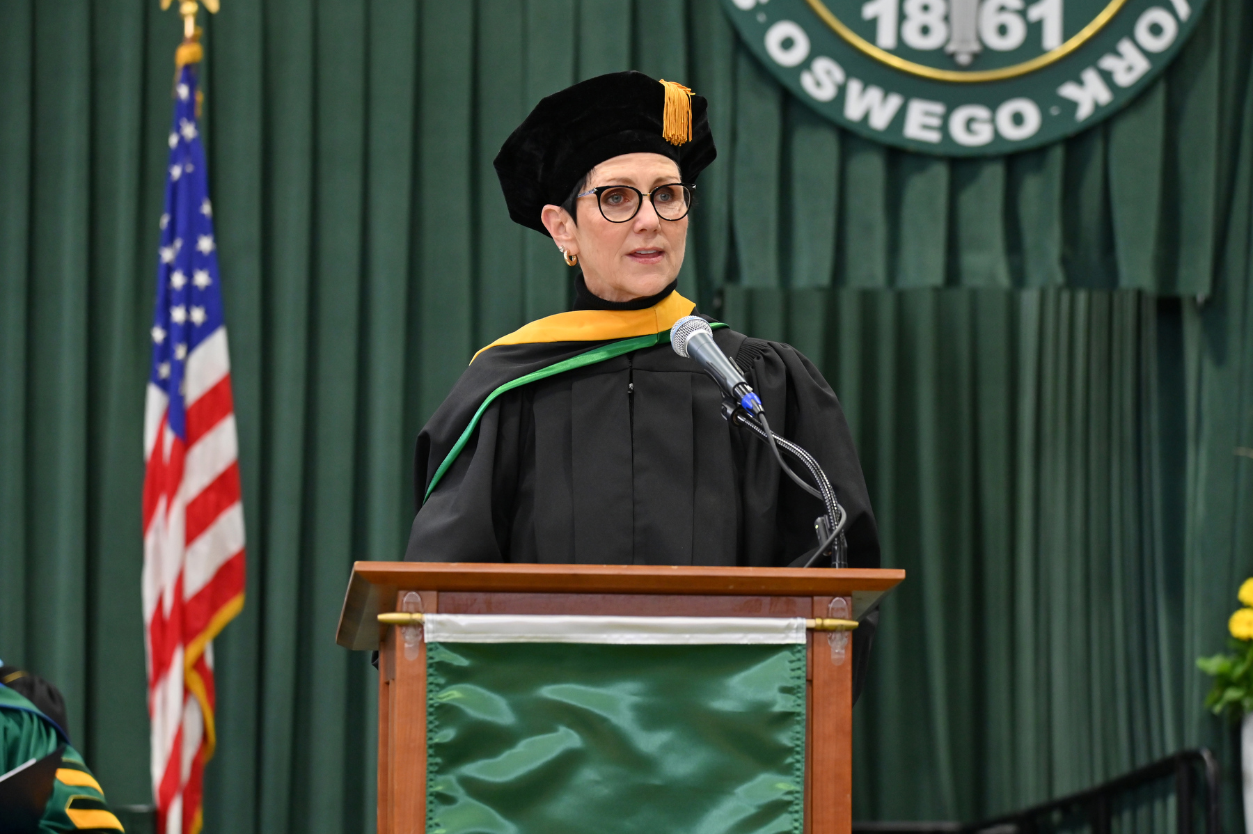 Mary Gibbons Canale '81, vice president for university advancement, is retiring this year after a noteworthy career of profound accomplishments of advancing SUNY Oswego. Canale had the opportunity to introduce the alumni banner presenters one more time during the Dec. 14 Commencement ceremony.