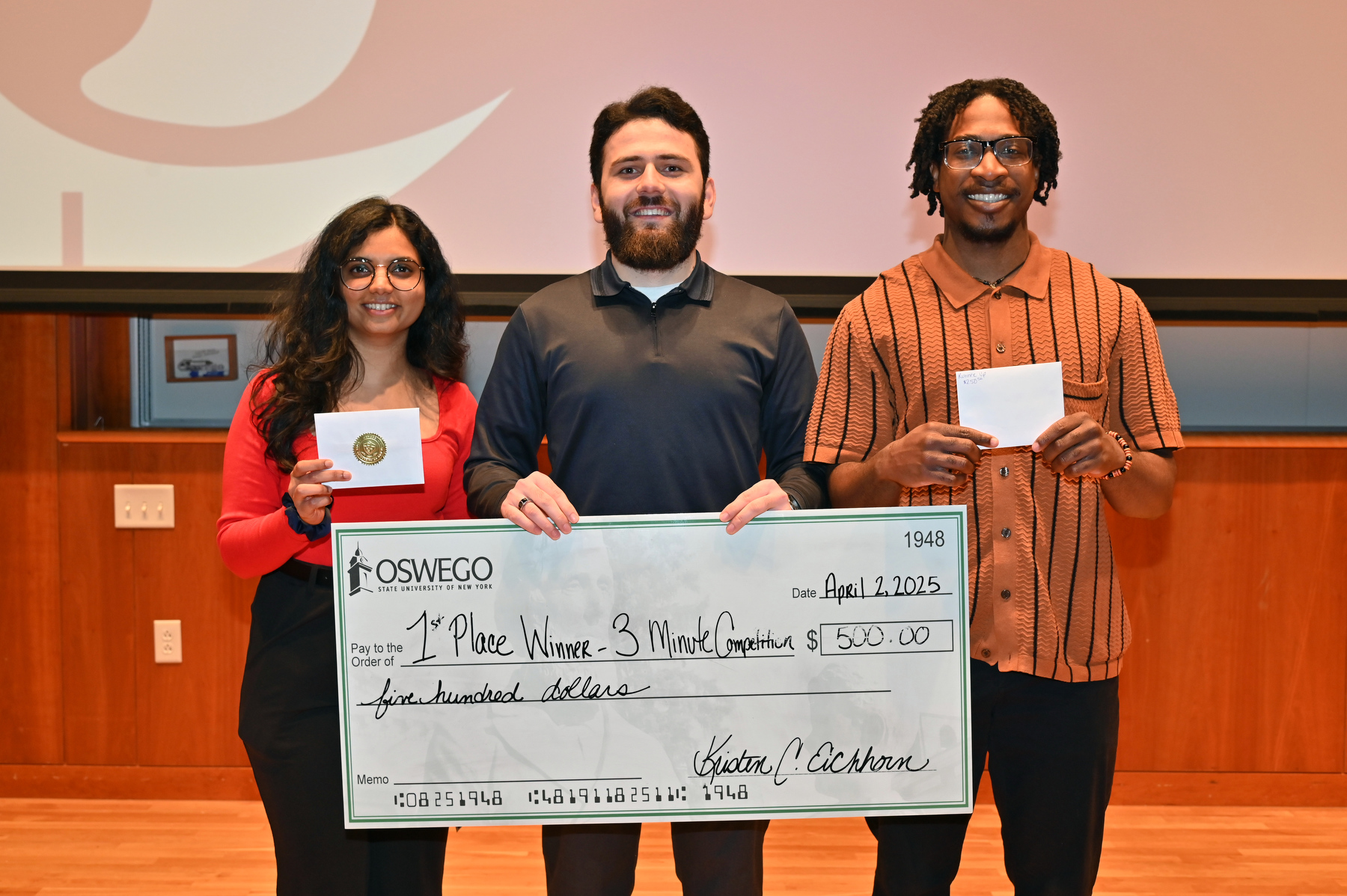 This year’s 3 Minute Thesis competition featured presentations on exceptional research from graduate students on April 2. Shown from left arePeople's Choice winner Manali Shivapurkar, first place winner Muhammad Musozoda and runner up Michael-Daniel Vodzogbe. 