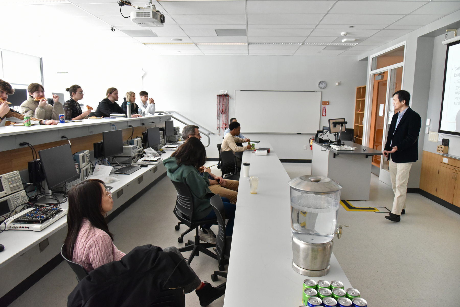 The Electrical and Computer Engineering Department (hosted an open house for high school students April 4 in the Shineman Center which included a tour of the engineering labs and presentations about the ECE program at SUNY Oswego. Pictured, associate professor Sungeun Kim leads an information session for the student group in the lab. The event was part of Engineering Week, sponsored by Micron Technologies.
