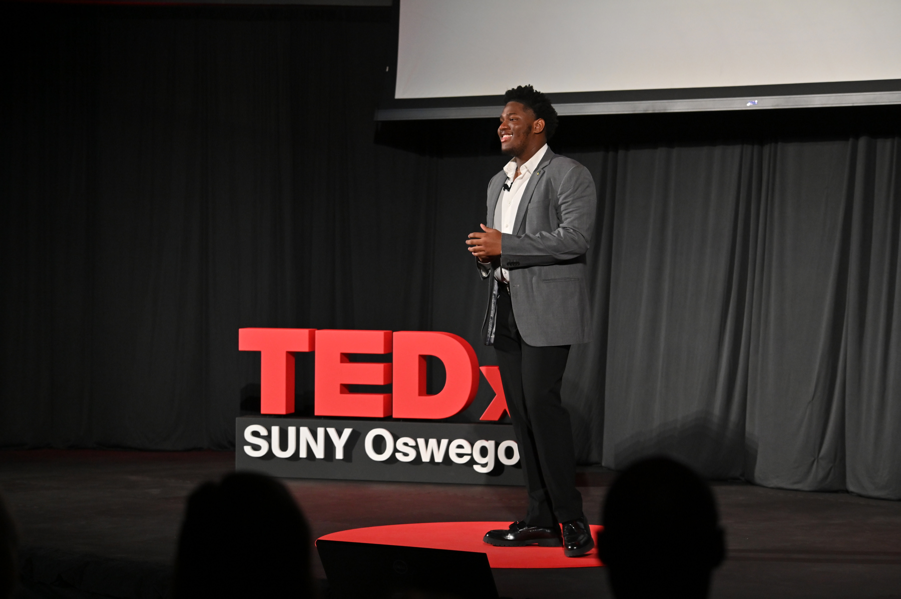 SUNY Oswego Student Association President Aiden R.J. Wilson, an international student from the Bahamas, speaking to the TEDxSUNY Oswego audience about "Sowing Seeds and Reaping Opportunities."