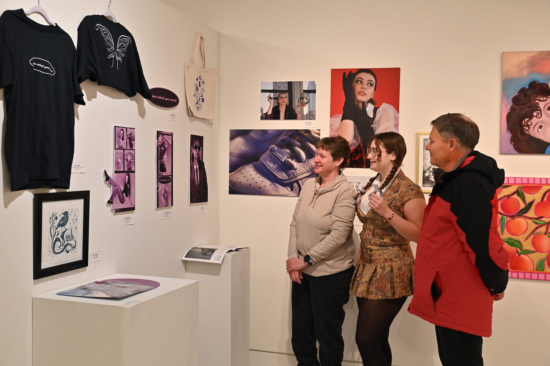 The opening reception for the Fall 2025 Bachelor of Fine Arts (BFA) Exhibition was held Dec. 5, a show of artworks which ran Dec. 2 through 12 in Tyler Art Gallery. Art work by 15 graduating BFA students included that of graduating senior Jamie Biggers, showing with her parents her works in a variety of media at the exhibition.