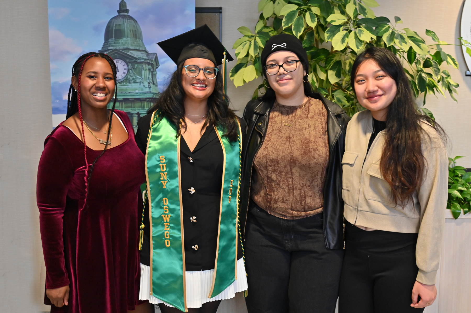 Graduate Chloe Emestica (second from left), who earned a degree in English and creative writing, celebrates with friends in the reception area in Marano Campus Center after the ceremony.