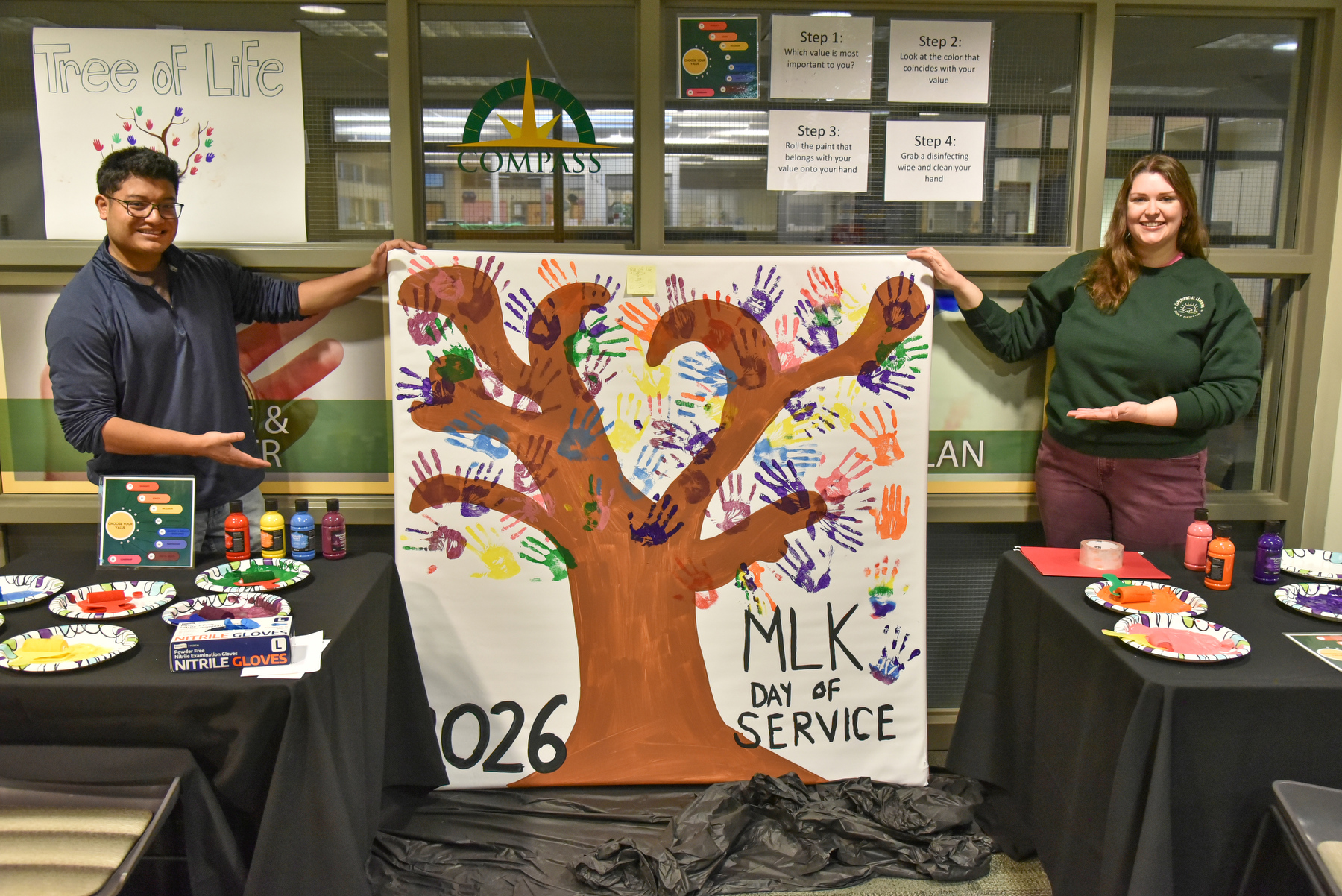 The Martin Luther King Jr. Day of Service features the vibrant "Tree of Life" poster, imprinted with multi-colored hand prints of students and event volunteers.