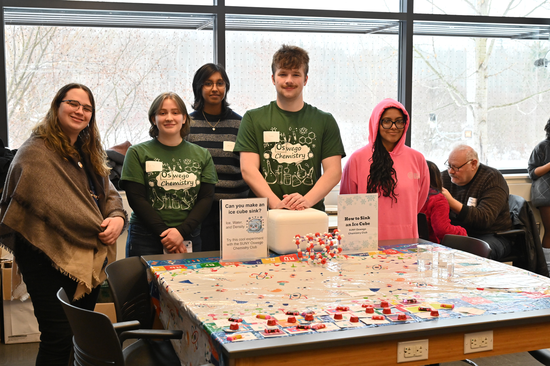 Rice Creek Field Station's annual Celebrate Snow Winter Festival included science demonstrations, such as chemistry students in a lab classroom showing the physics of floating ice.