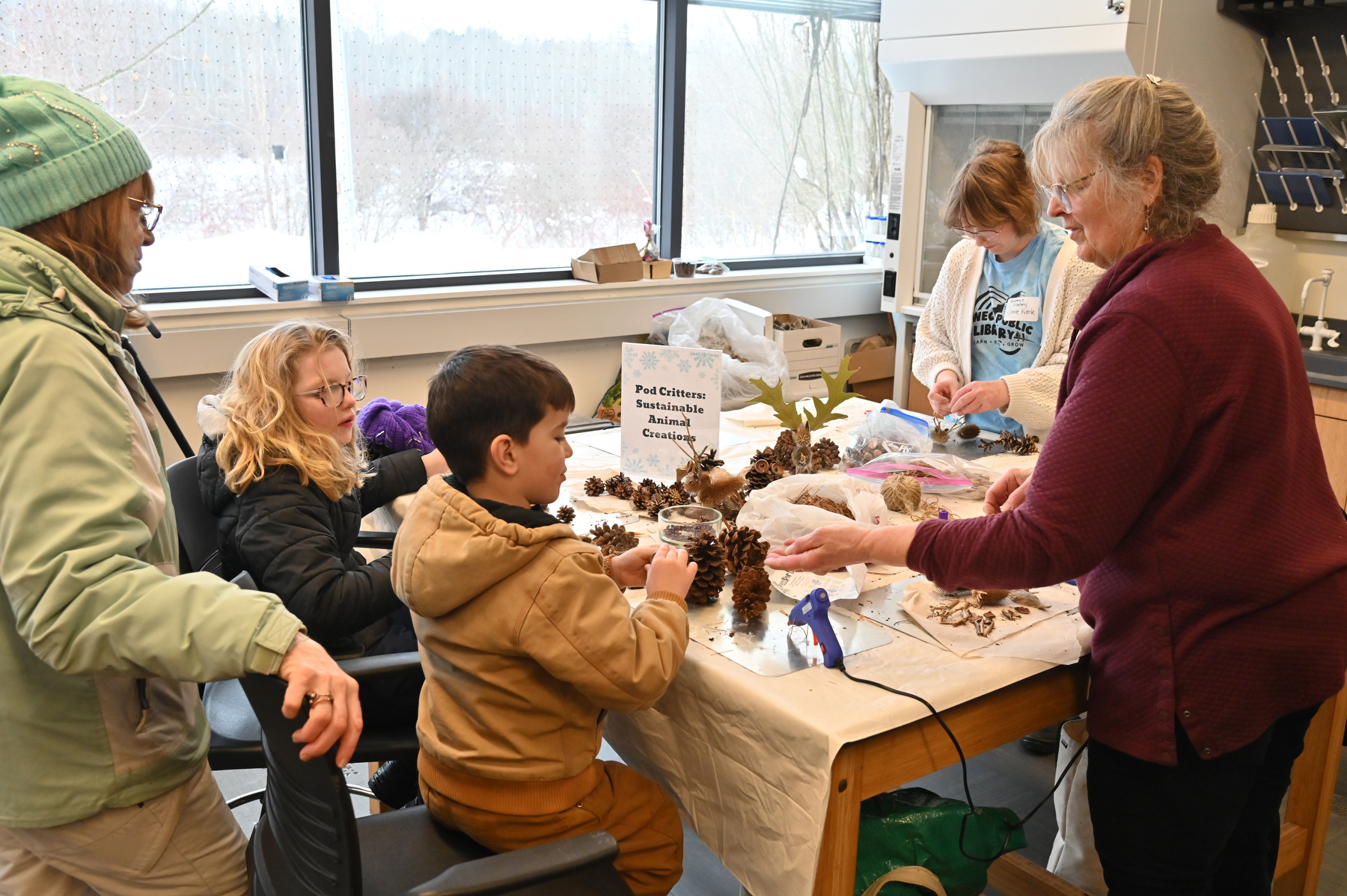 Rice Creek Field Station's annual Celebrate Snow Winter Festival on Saturday, Feb. 14, provided free activities for visitors of all ages. Linda Knowles of Rice Creek Field Station helps kids create animals from pine cones and other organic materials.
