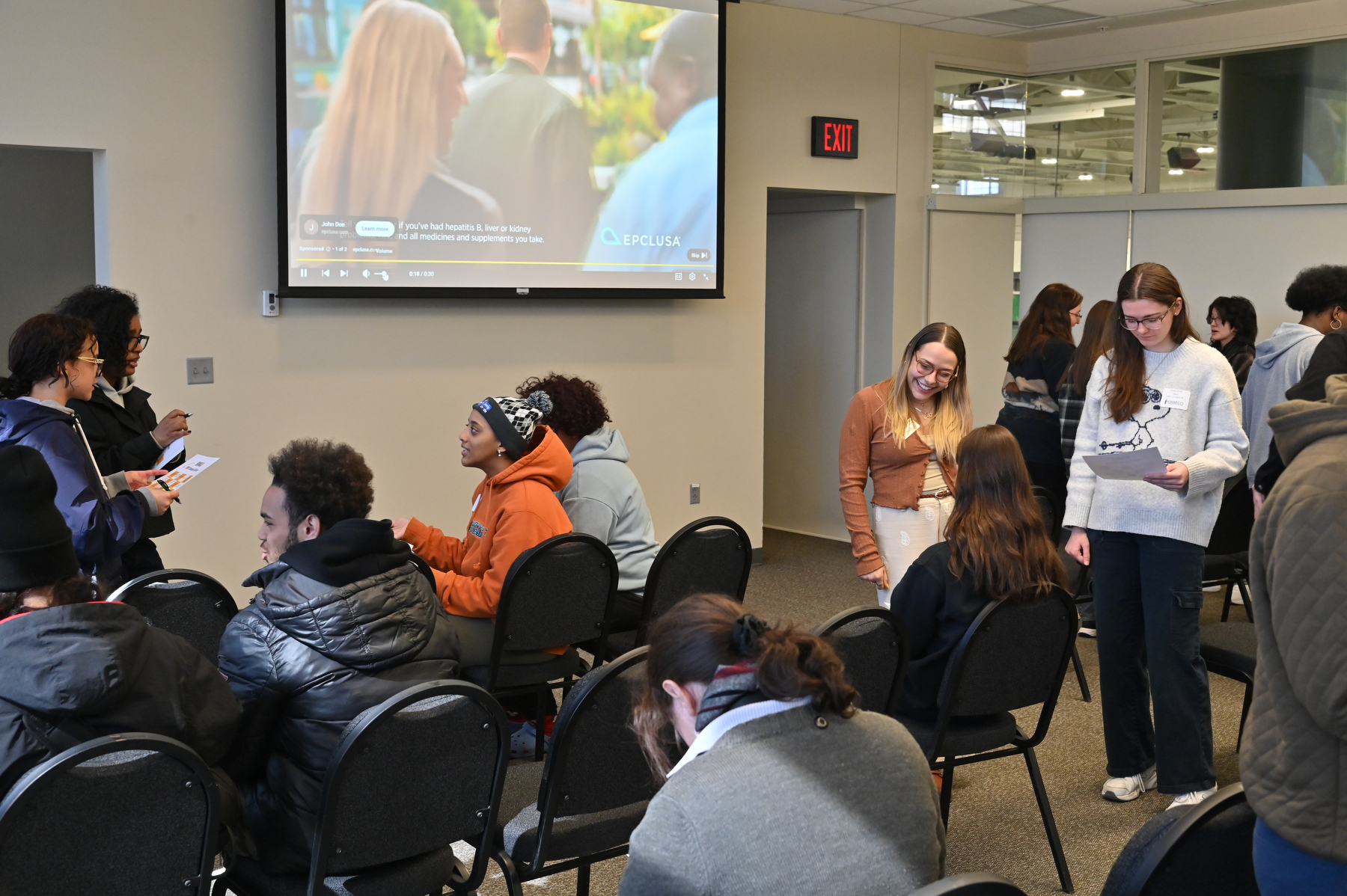 Admissions Counselor Gabrielle Golfo (center) greets future Lakers in Marano Campus Center for student service presentations and a fun Admitted Student Mingle session during the March 27 Admitted Student Day.