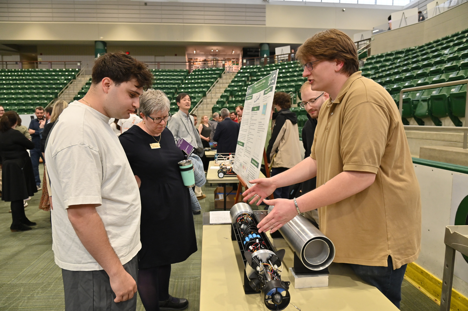 At the 2026 Quest poster session, electrical and computer engineering majors Spencer Evans and Tom Mendelis present their "Autonomous Underwater Vehicle" project, an interdisciplinary research vessel that can be used to study the Lake Ontario ecosystem.