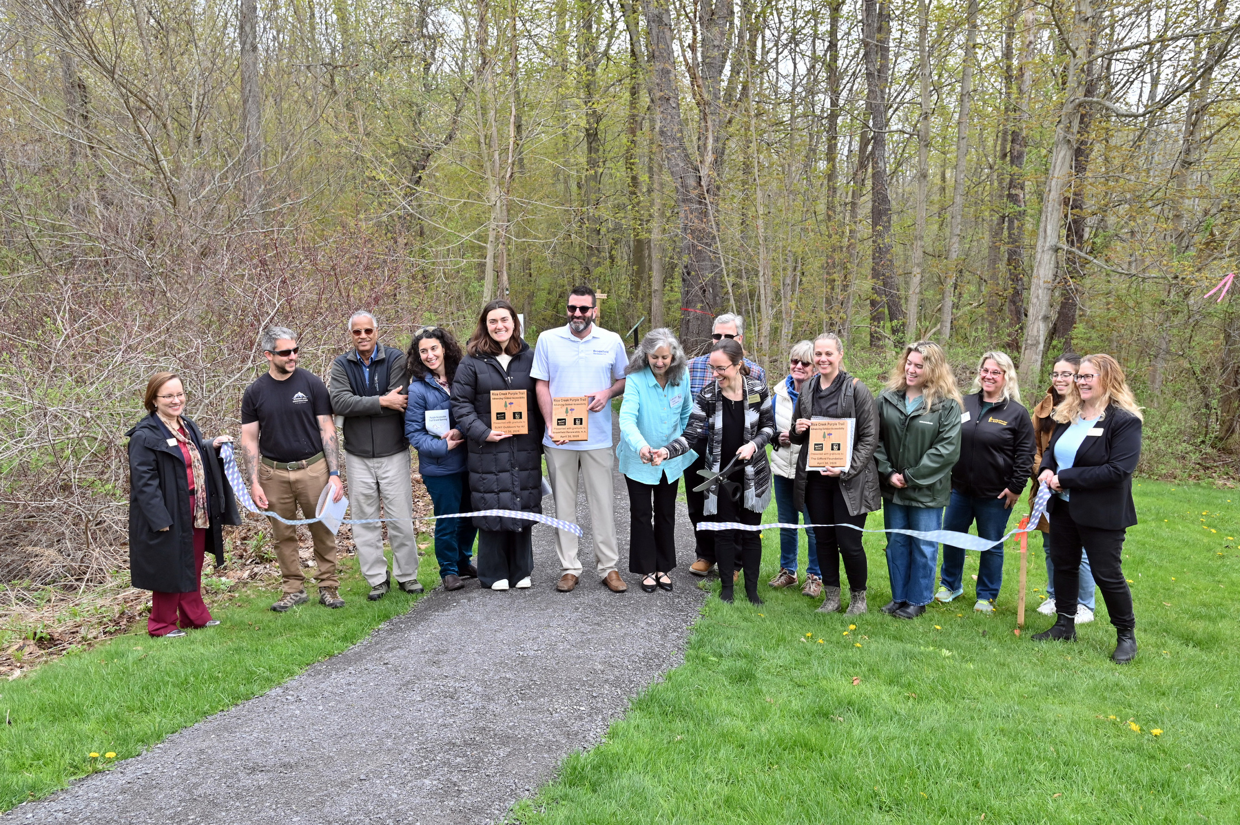 Rice Creek Field Station held a ribbon cutting ceremony April 30 to celebrate the Grand Opening of its new Purple accessible trail. Designed to promote inclusive access to nature, this 0.6-mile trail features gentle slopes and stable, flat surfaces of packed stone dust and boardwalks. Meeting U.S. Forest Service Trail Accessibility Guidelines, the Purple Trail is suitable for many people who use wheelchairs, walkers and strollers, and provides an enhanced experience for everyone.