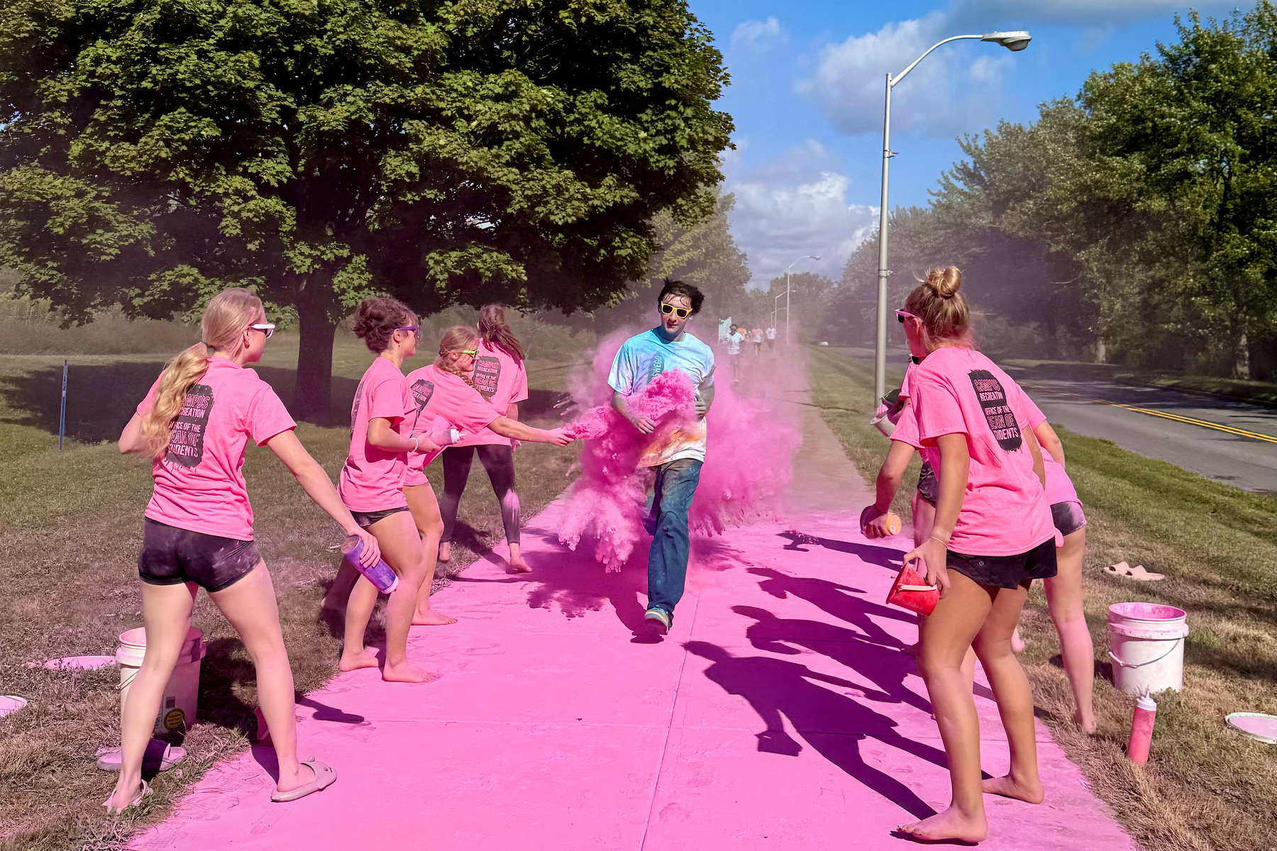 Volunteers including the Laker women’s hockey team (pictured) and men’s basketball team helped distribute powder during the Color Oswego run/walk on Aug. 29. 