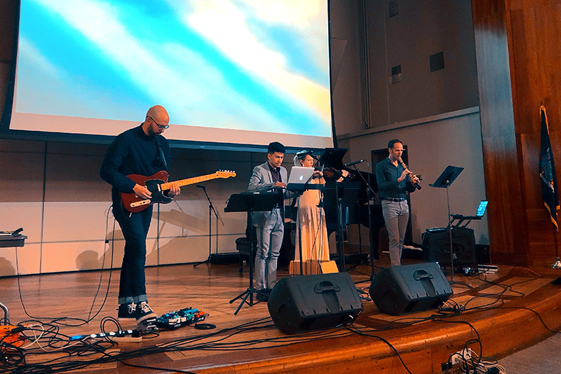 Michael James Olson (left) performed in the college’s Ke-Nekt music series on Nov. 6 in the Sheldon Hall ballroom with Oswego students and faculty sometimes accompanying him