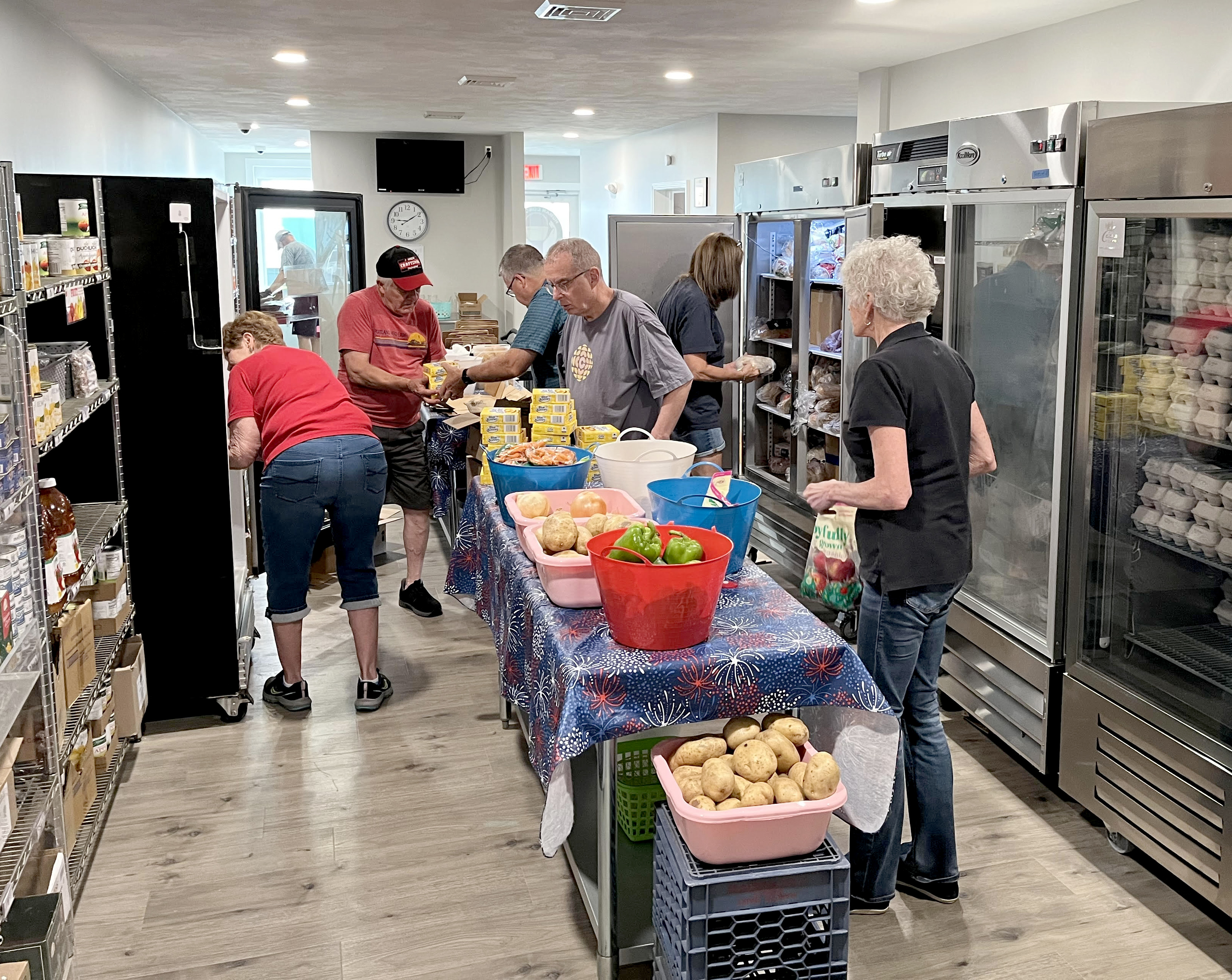 Community members from the Retired and Senior Volunteer Program (RSVP) regularly help unload and organize deliveries to Oswego's Human Concerns Center from the Food Bank of New York, including this shipment on July 9. 