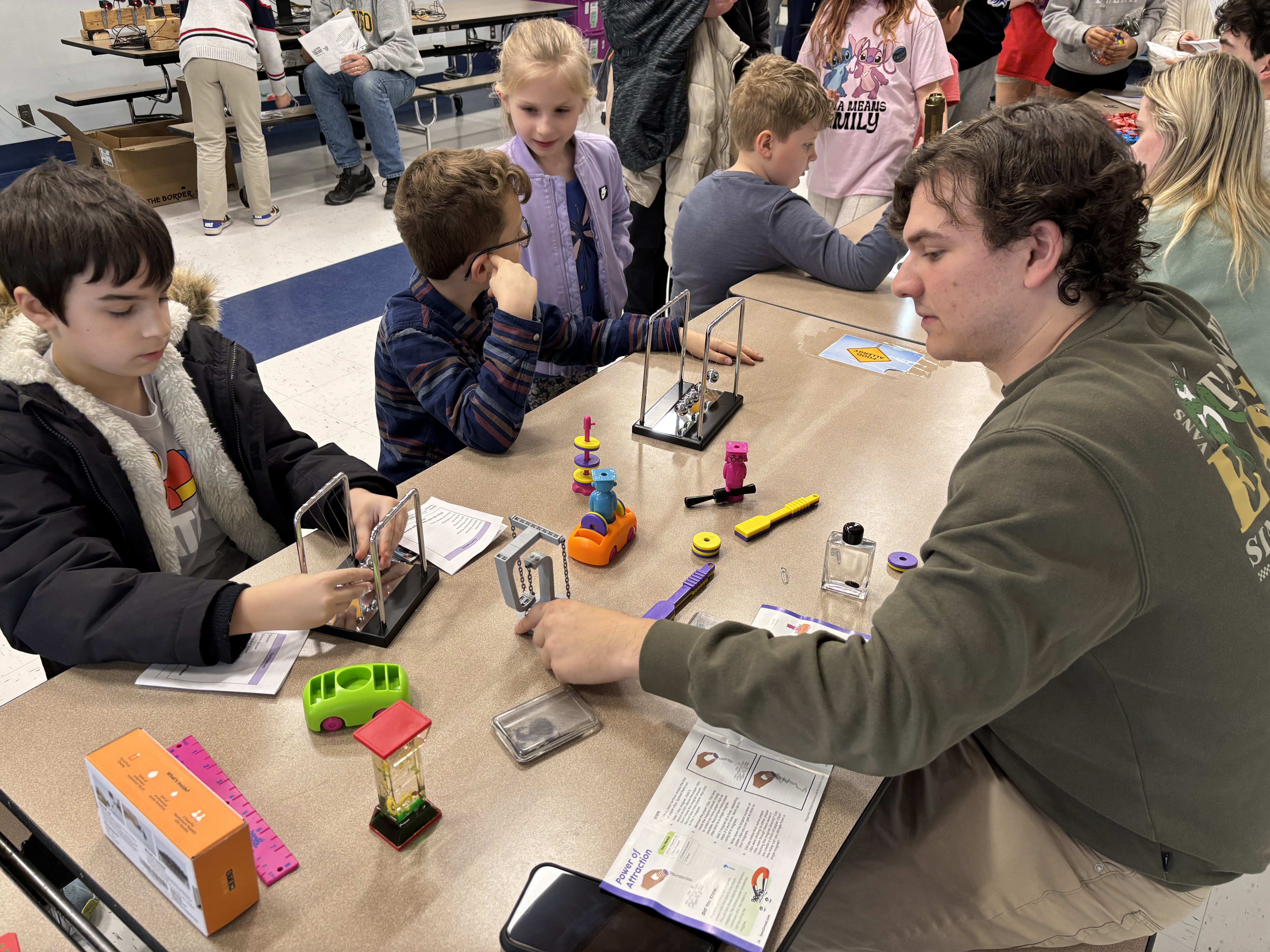 SUNY Oswego was well represented by faculty, staff and students at Kingsford Park Elementary School’s STEAM Night in Oswego on March 27. Around 100 elementary students visited the university’s activities tables, including this one staffed by Oswego students.