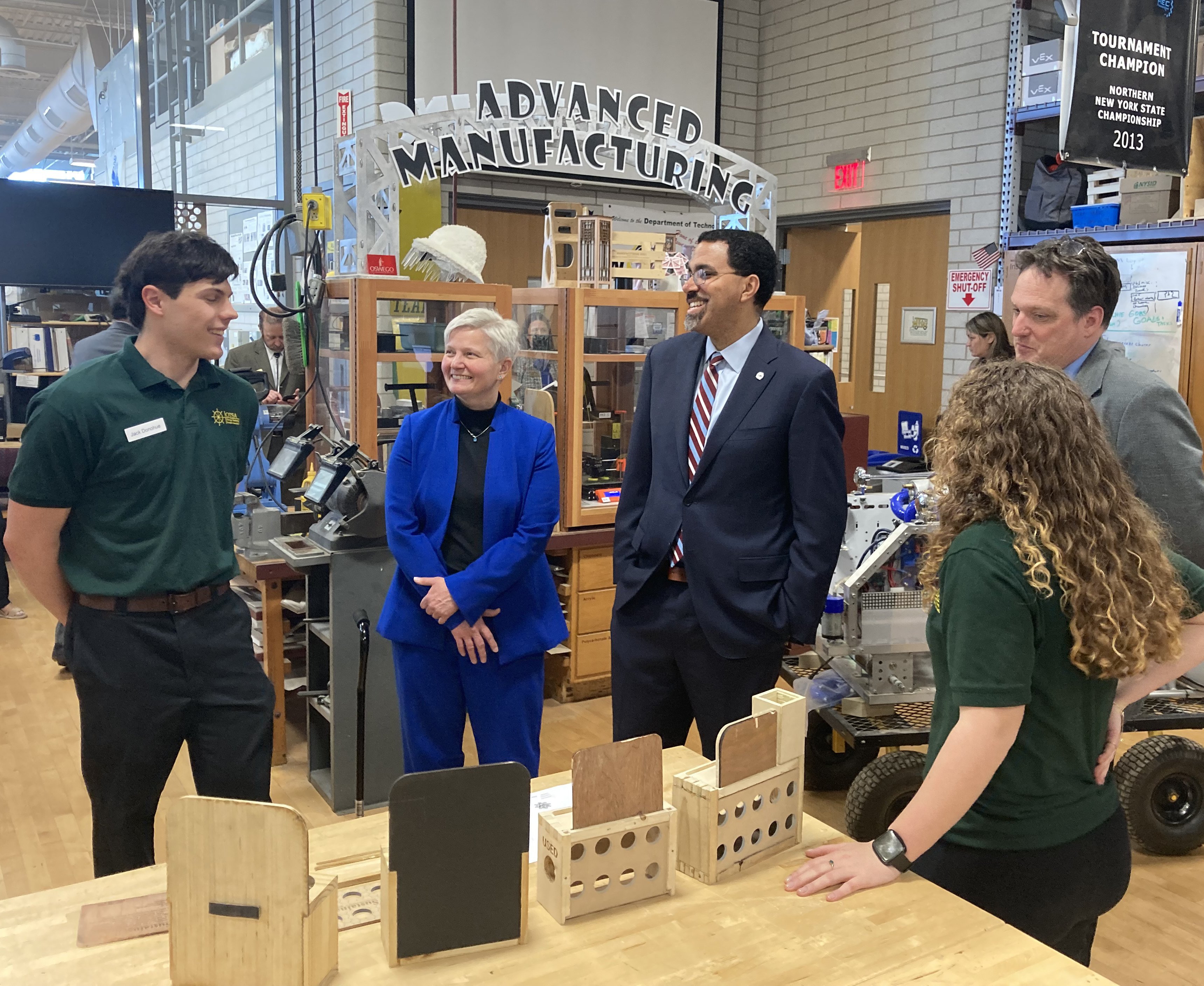 Chancellor John B. King Jr. speaks with students in a technology education lab