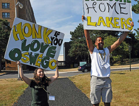 Students holding Oswego signs